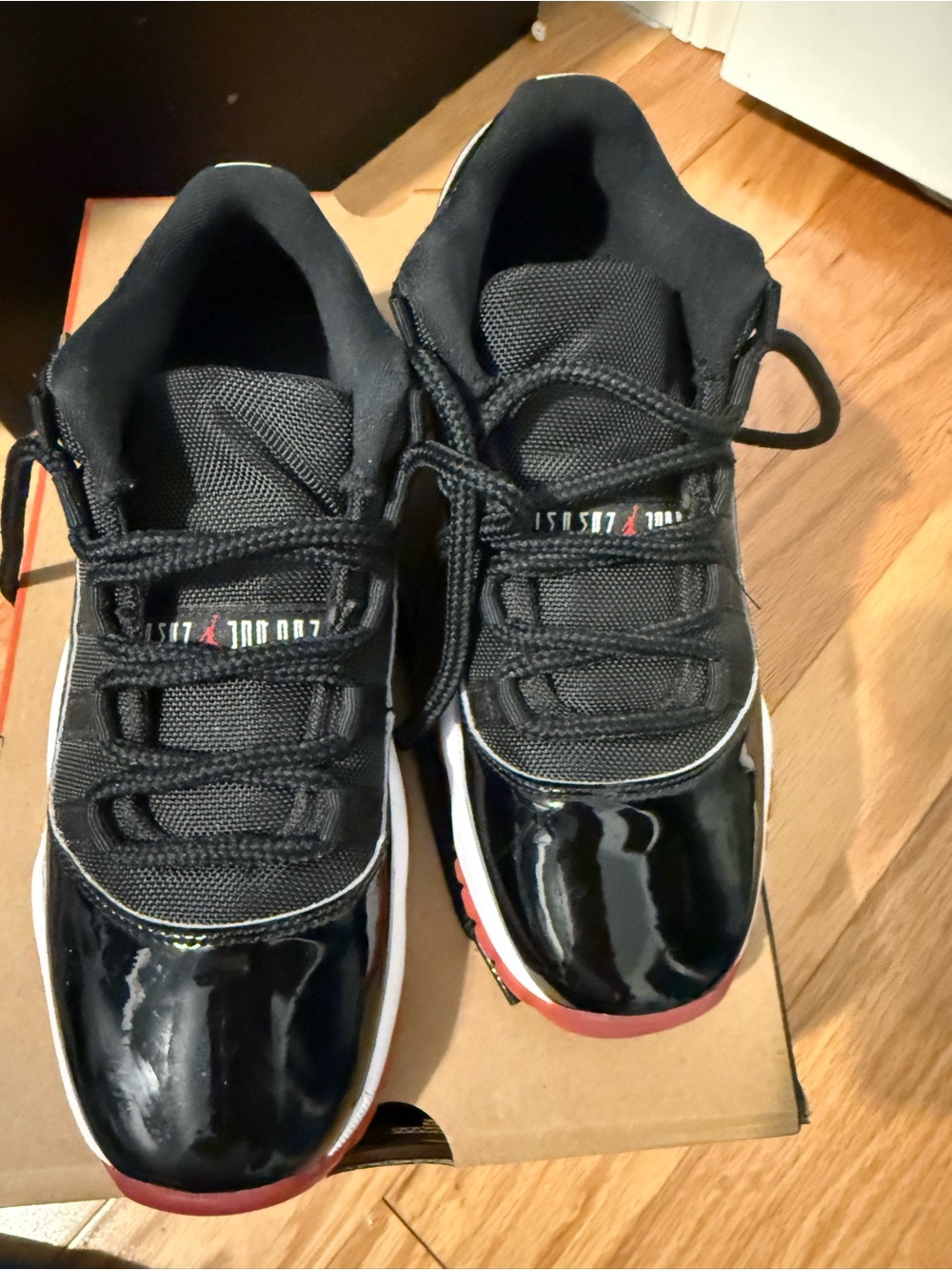Air Jordan Black Patent Low-Top Sneakers with Red Accents